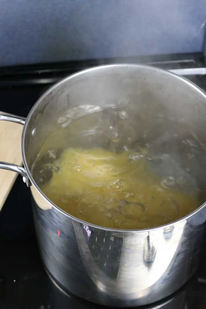 Boiling pot of water with lasagna noodles