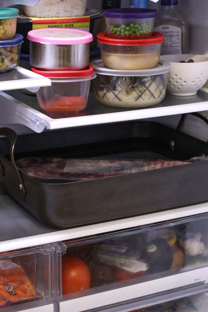 Frozen ribs thawing in water in the refrigerator